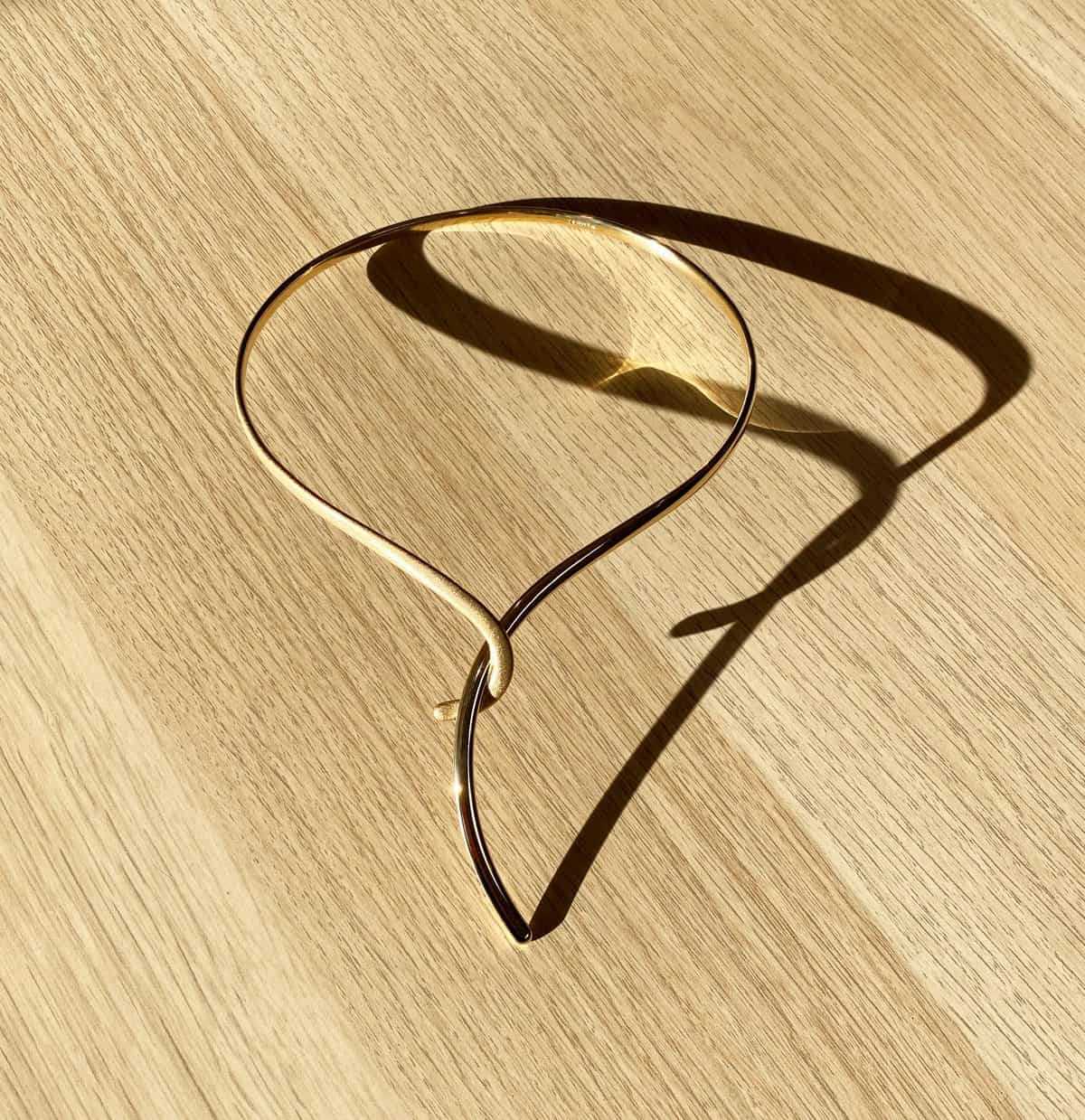Gold torc on wood